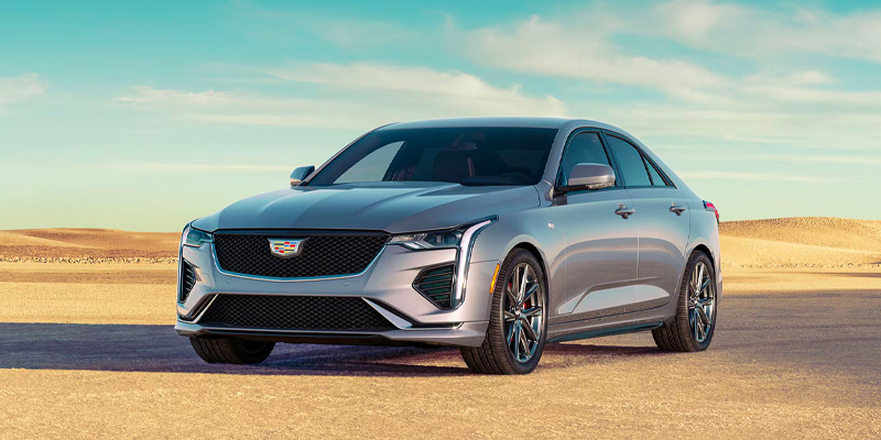 Front drivers side view of a silver 2025 Cadillac CT4 parked in a desert