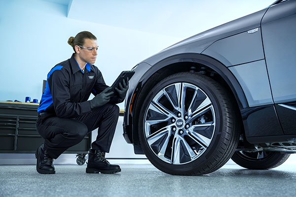 Cadillac Service Advisor ensuring a vehicle's wheel bearings are well maintained