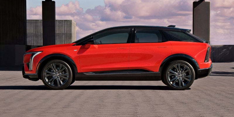 A red 2025 Cadillac OPTIQ is parked on road