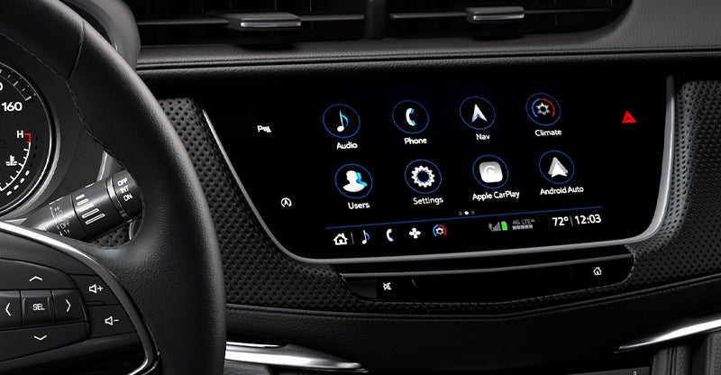 Cadillac infotainment touchscreen showing app icons and climate controls in dashboard view.