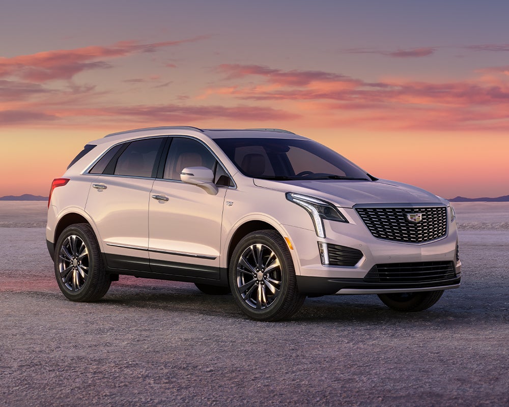2026 Cadillac XT5 SUV parked at sunset, front three-quarter view on open road.