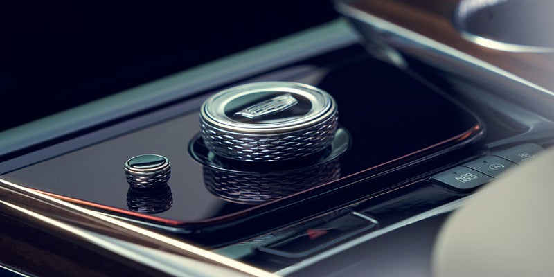 Close-up of the 2026 Cadillac Escalade's premium gear shift and control dial, highlighting its premium design.