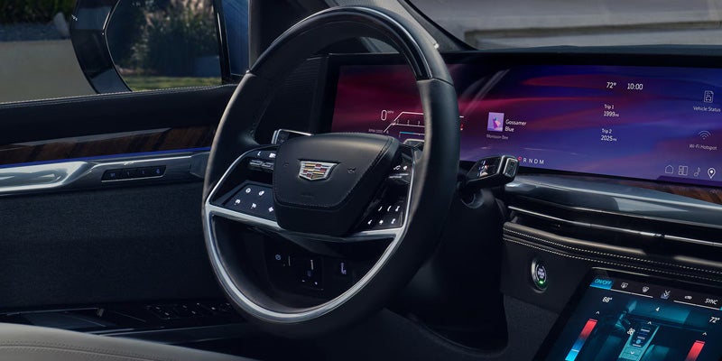 Close-up of the 2026 Cadillac Escalade's steering wheel, highlighting the premium controls and digital display.