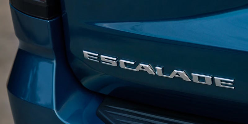 Close-up of the 2026 Cadillac Escalade badge, highlighting the sleek design and premium branding.