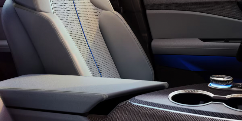 Close-up of Cadillac Optiq interior seat and center console.